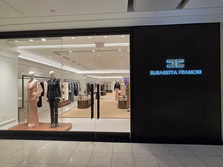 Illuminated Elisabetta Franchi storefront sign in a shopping mall