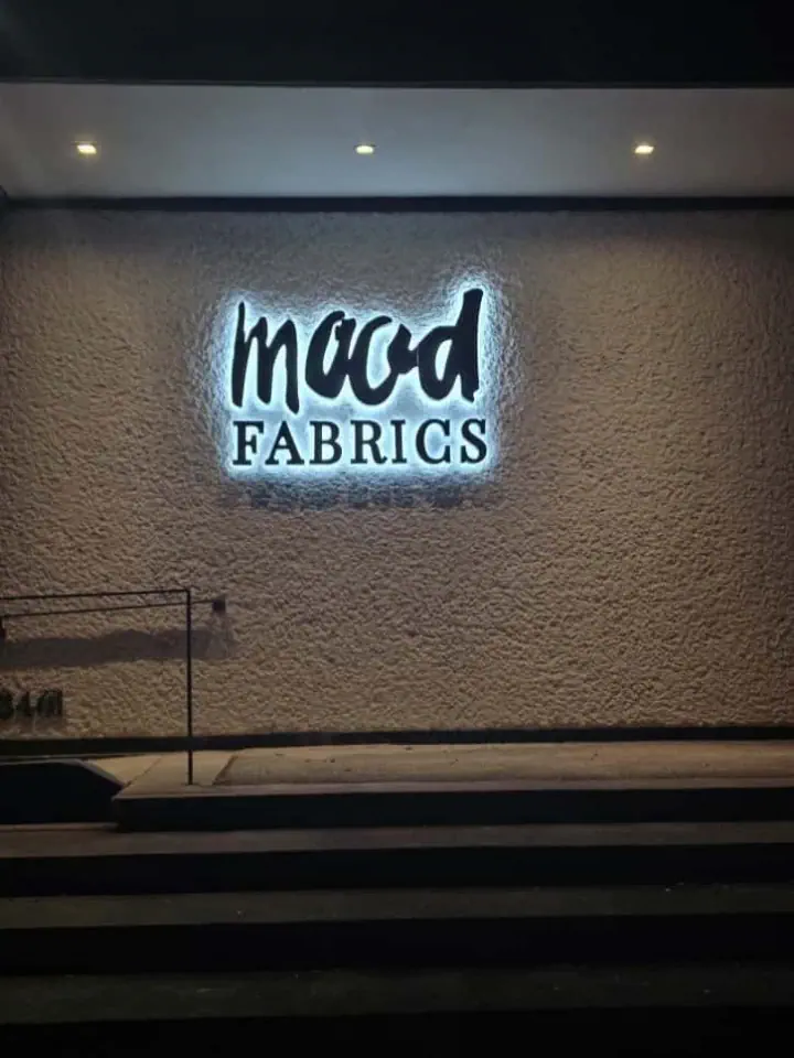 Mood Fabrics sign mounted on an exterior building wall