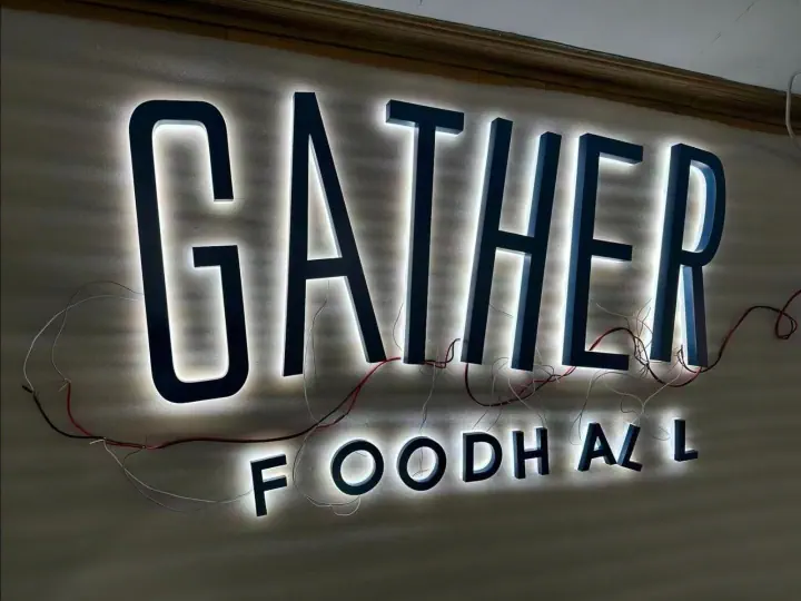 Close-up of illuminated Gather Food Hall lettering