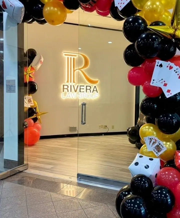 Illuminated Rivera logo on an interior wall