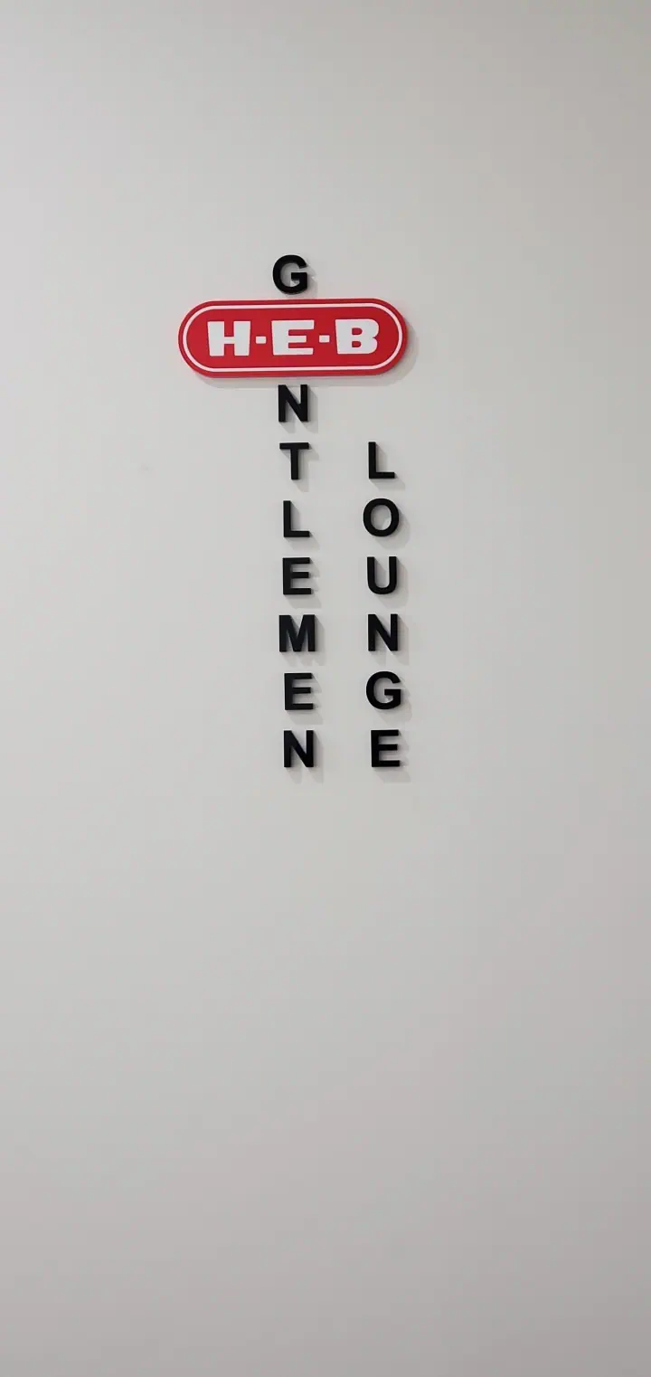 Gentlemen’s Lounge sign mounted on an interior wall