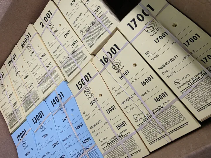 Stacks of numbered printed event tickets on a table