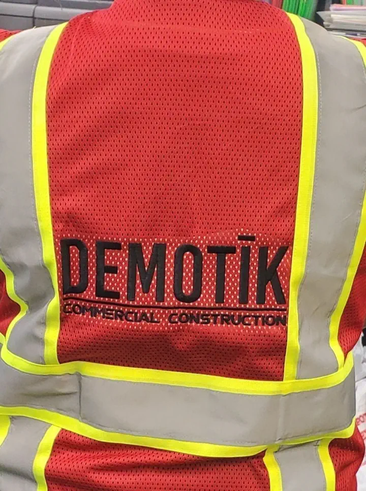 Branded high-visibility safety vest shown from the back