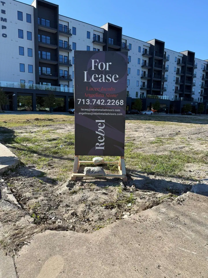 Freestanding For Lease sign outside an apartment building