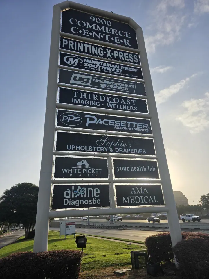 Tall multi-tenant pylon sign outside a shopping center