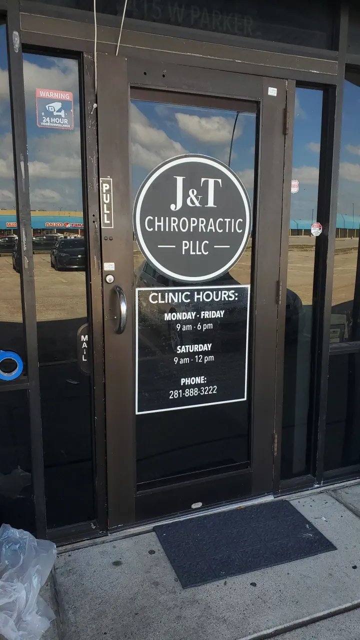 J&T Chiropractic branding on a glass entrance door