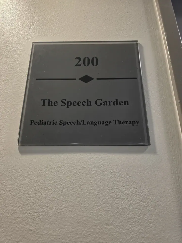 Room 200 directional sign mounted beside a door