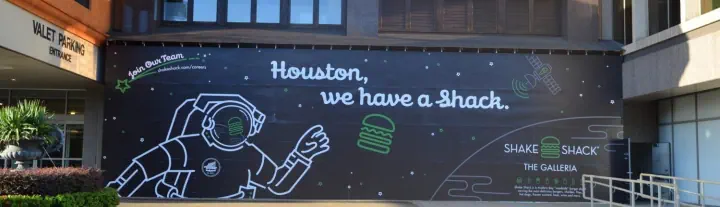 Houston, We Have a Shack mural across a storefront wall