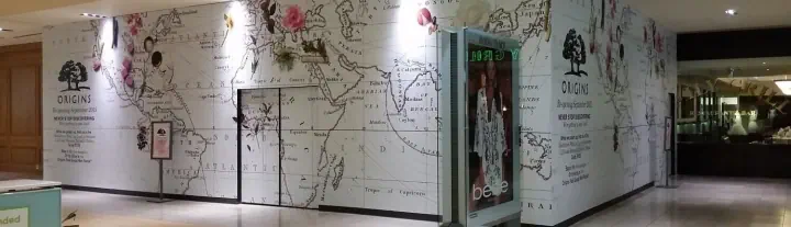 Large black-and-white illustrated wall graphics in an interior corridor
