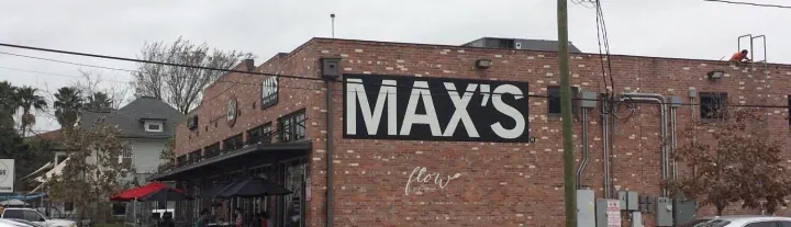 MAX’S exterior sign on a brick building