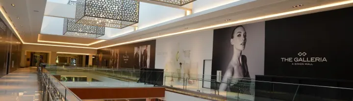 The Galleria storefront graphics along an indoor mall walkway