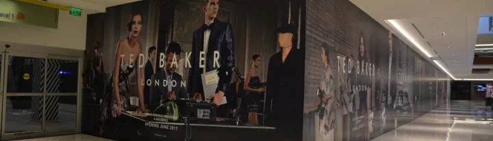 Ted Baker storefront graphics along a shopping mall corridor