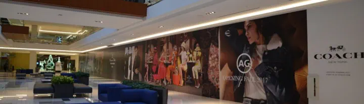 COACH fashion graphics across a long shopping mall wall