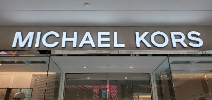 Michael Kors illuminated storefront letters in a shopping mall