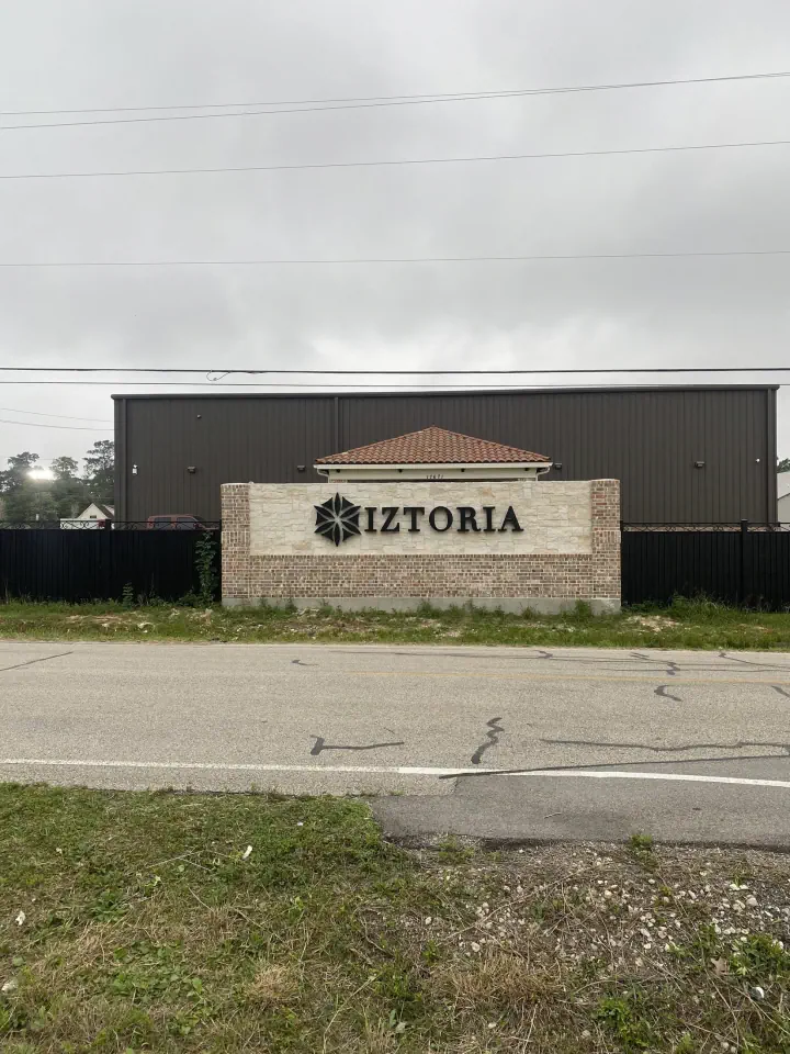 IZTORIA brick monument sign outside a commercial building