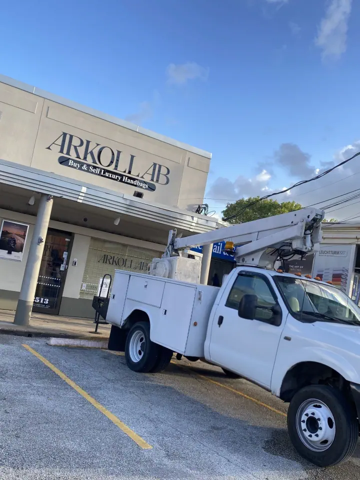 ARKOLLAB storefront sign with an installation truck parked outside