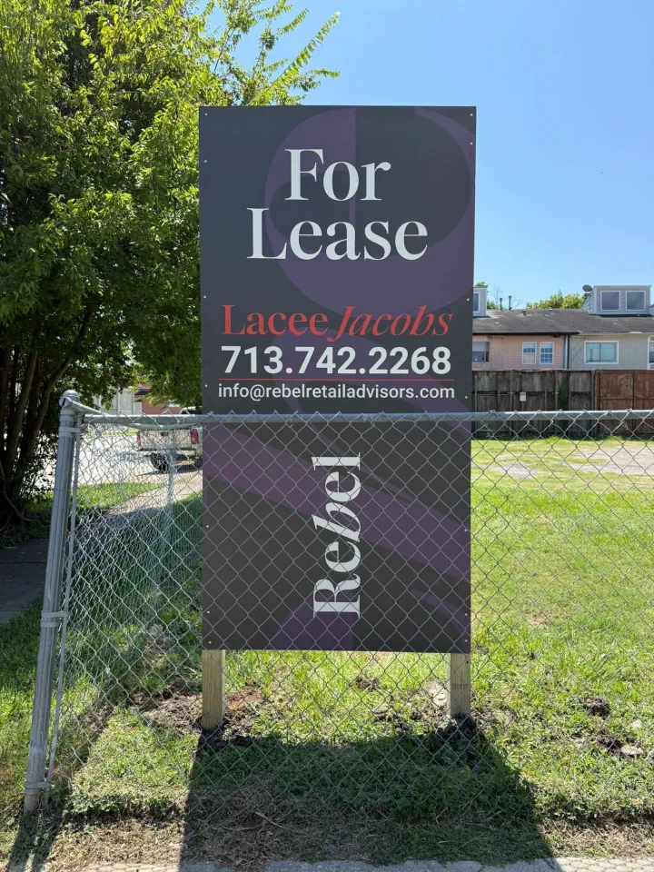 For Lease sign mounted on a chain-link fence