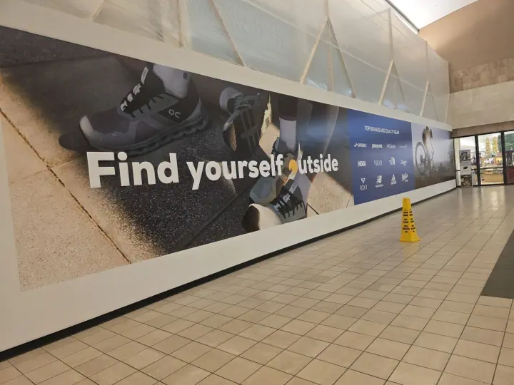 Large Find Yourself Outside wall graphic in a shopping mall