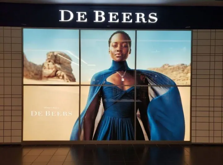 De Beers illuminated storefront sign in a shopping mall