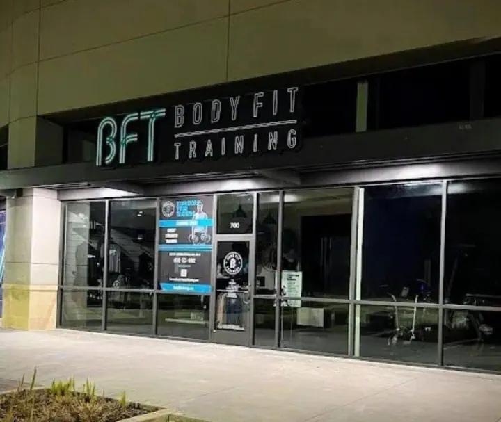 BFT Body Fit Training illuminated storefront sign at night