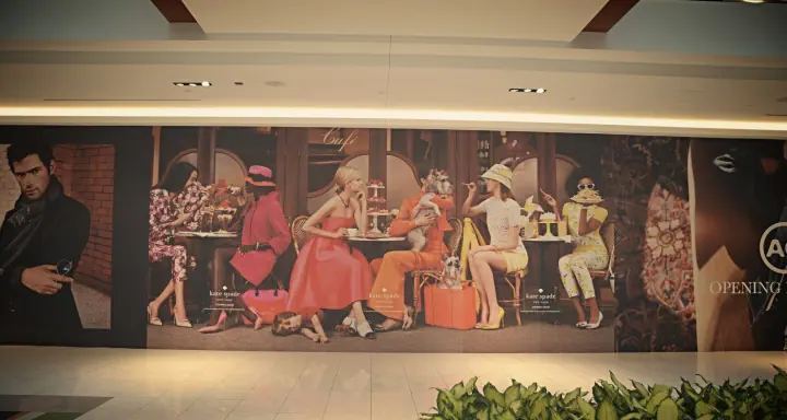 Kate Spade New York Coming Soon wall graphic in a shopping mall