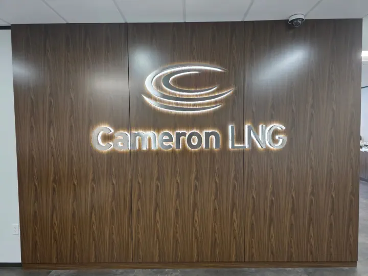 Cameron LNG backlit logo and channel letters on a wood-paneled lobby wall