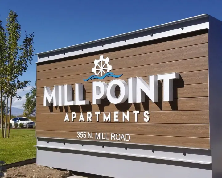 Mill Point Apartments monument sign with dimensional lettering and water-wheel logo