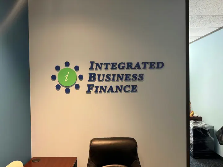 Integrated Business Finance dimensional logo and lettering on an interior wall