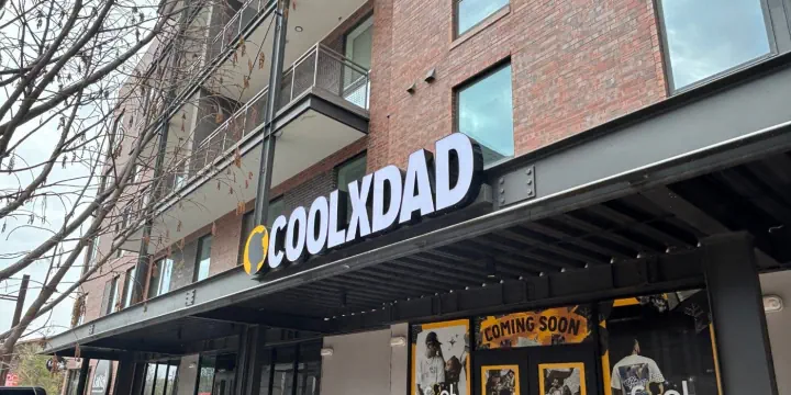 Dimensional COOLXDAD letters mounted above a storefront