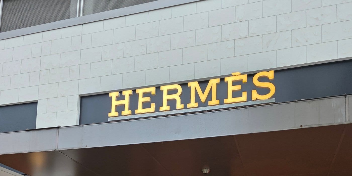 Illuminated dimensional storefront sign on a retail building facade